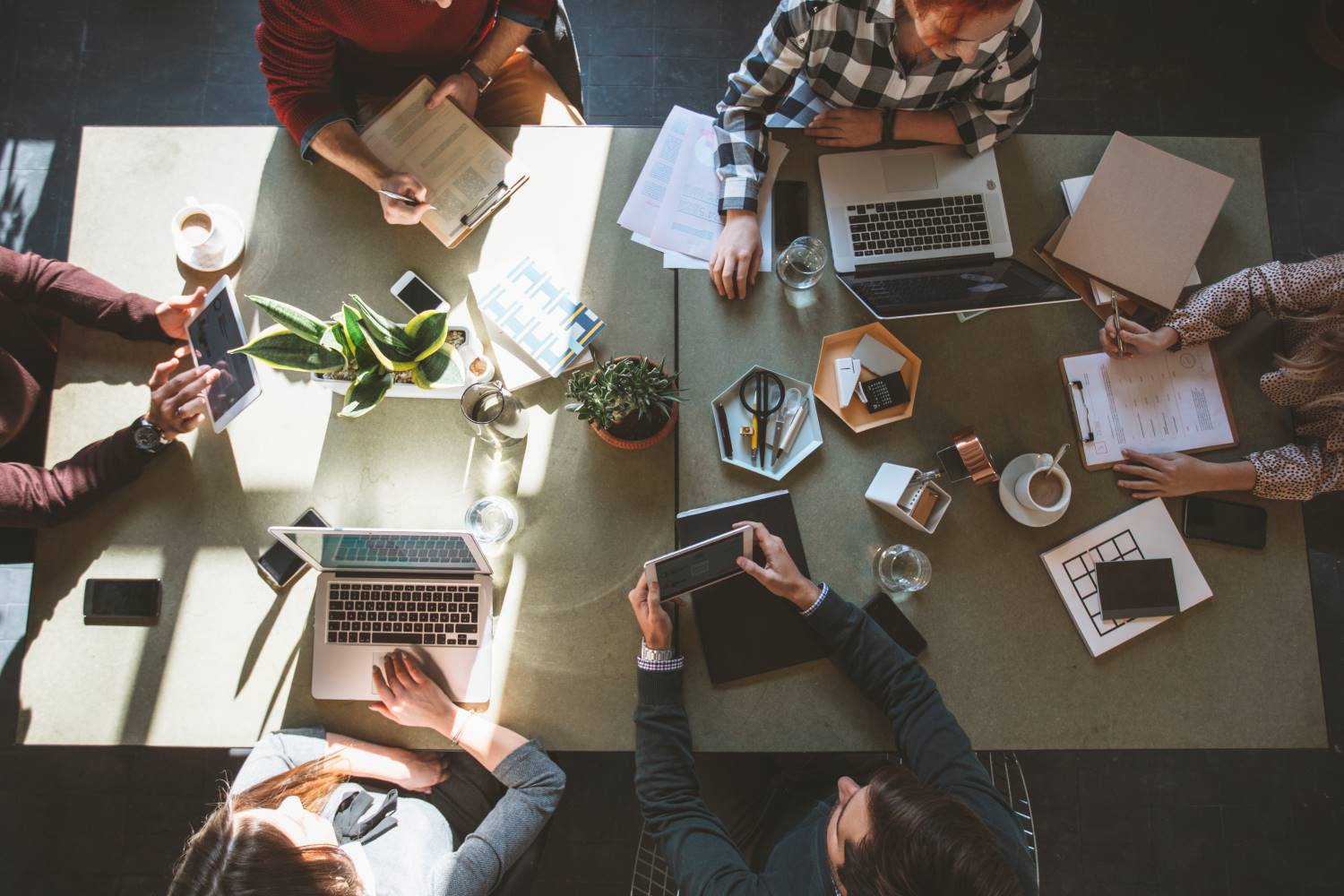 Businesspeople_Around_Table_Aerial People sitting at meeting table from above