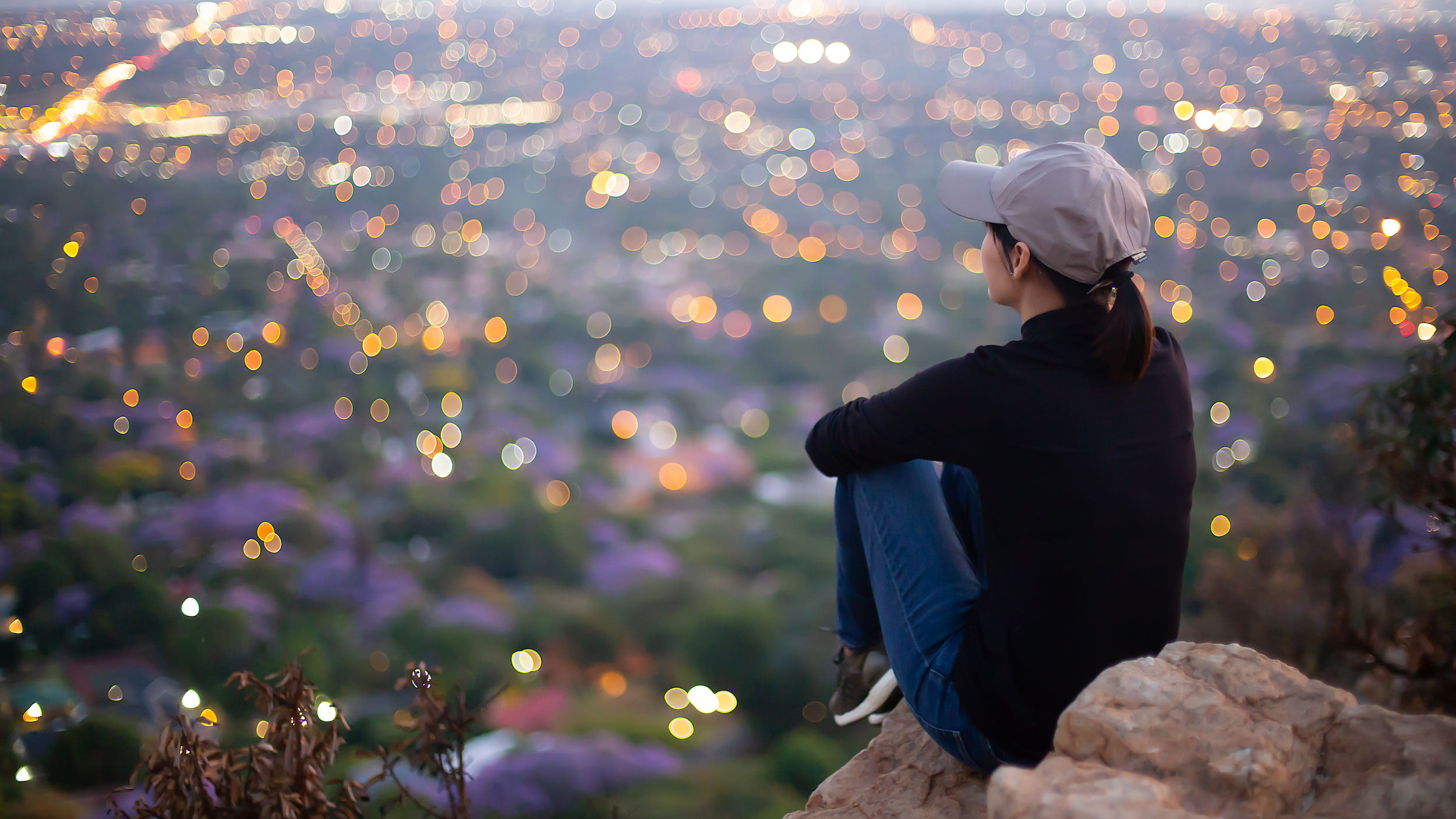 Asian_Woman_on_Cliff_Overlooking_City