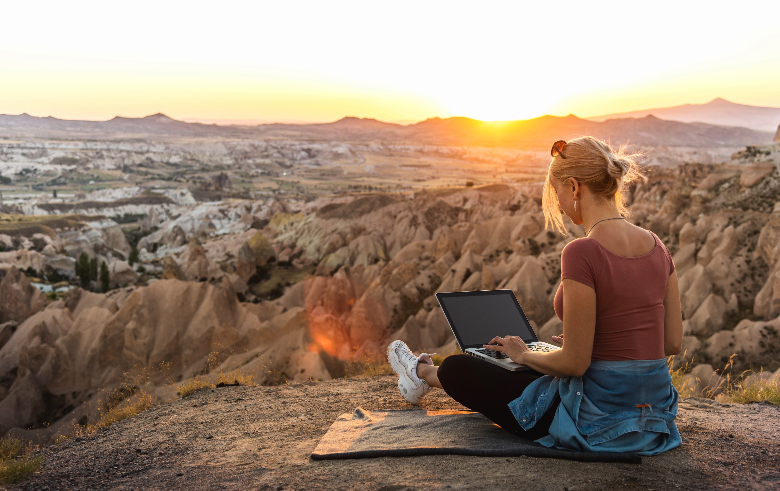 Young lady working on her laptop outside Young lady working on her laptop outside
