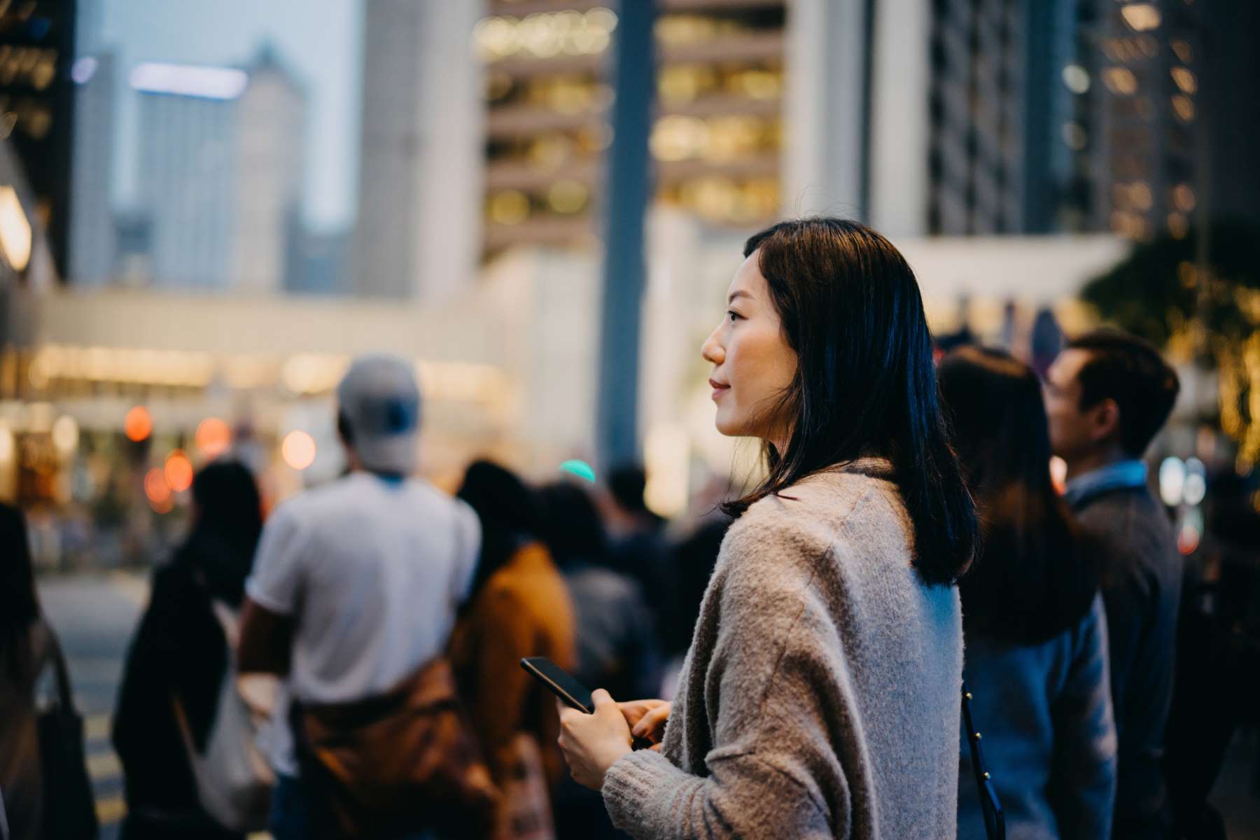 Woman With Smartphone In Busy Downtown District Woman With Smartphone In Busy Downtown District