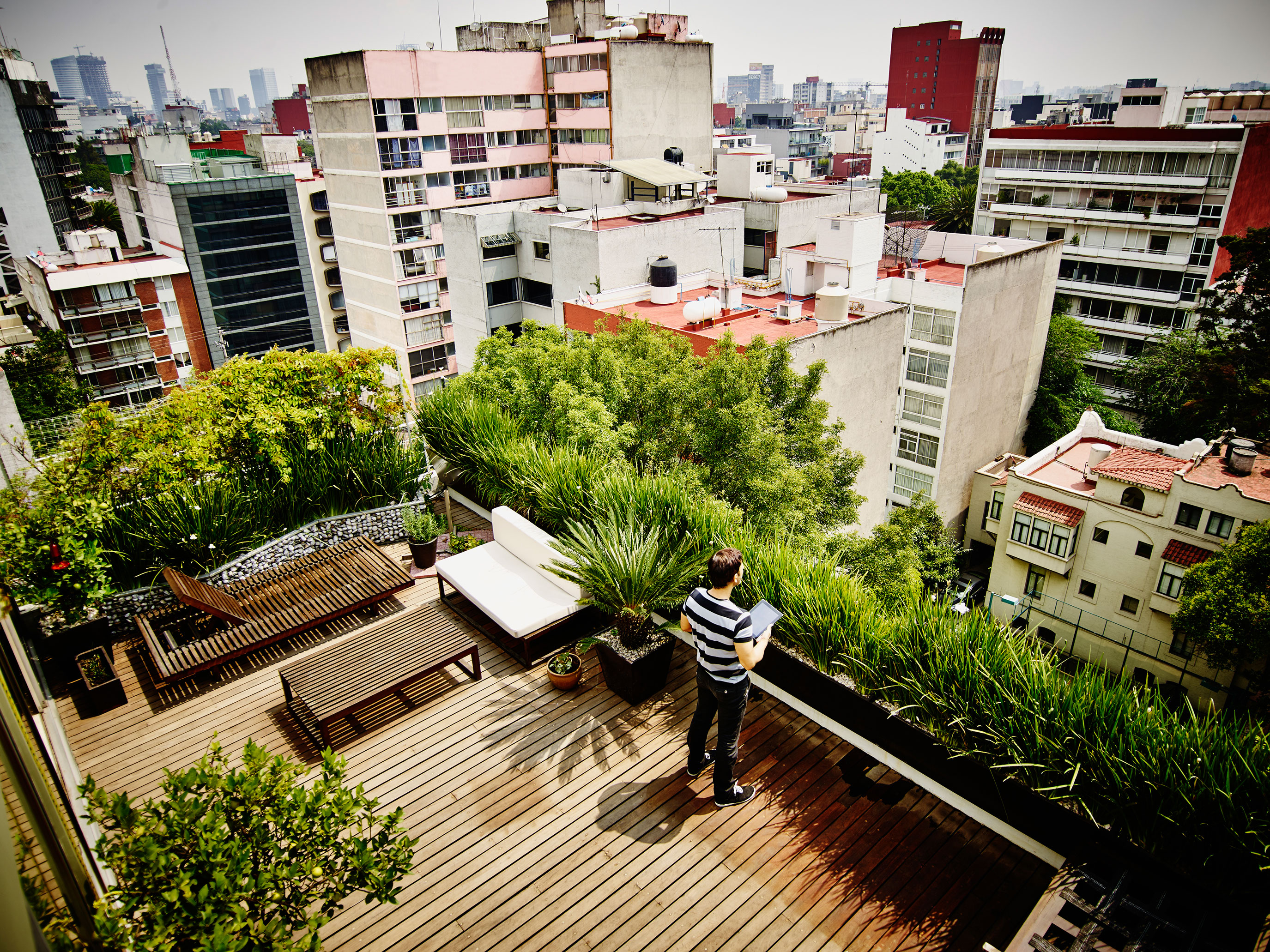 Man_Standing_on_Rooftop_with_Tablet