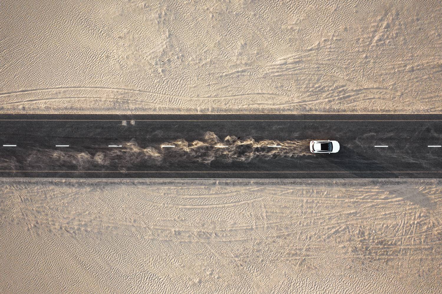 Car_On_Desert_Road_Aerial_Horiz Car Driving On Desert Road