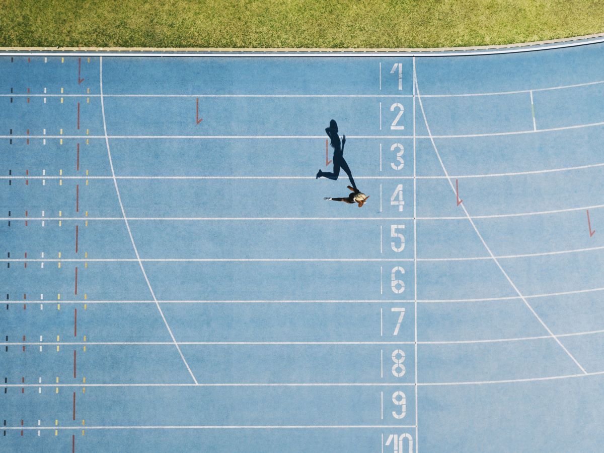 Running_on_Track_Aerial Female sprinter running on track nearing the finals