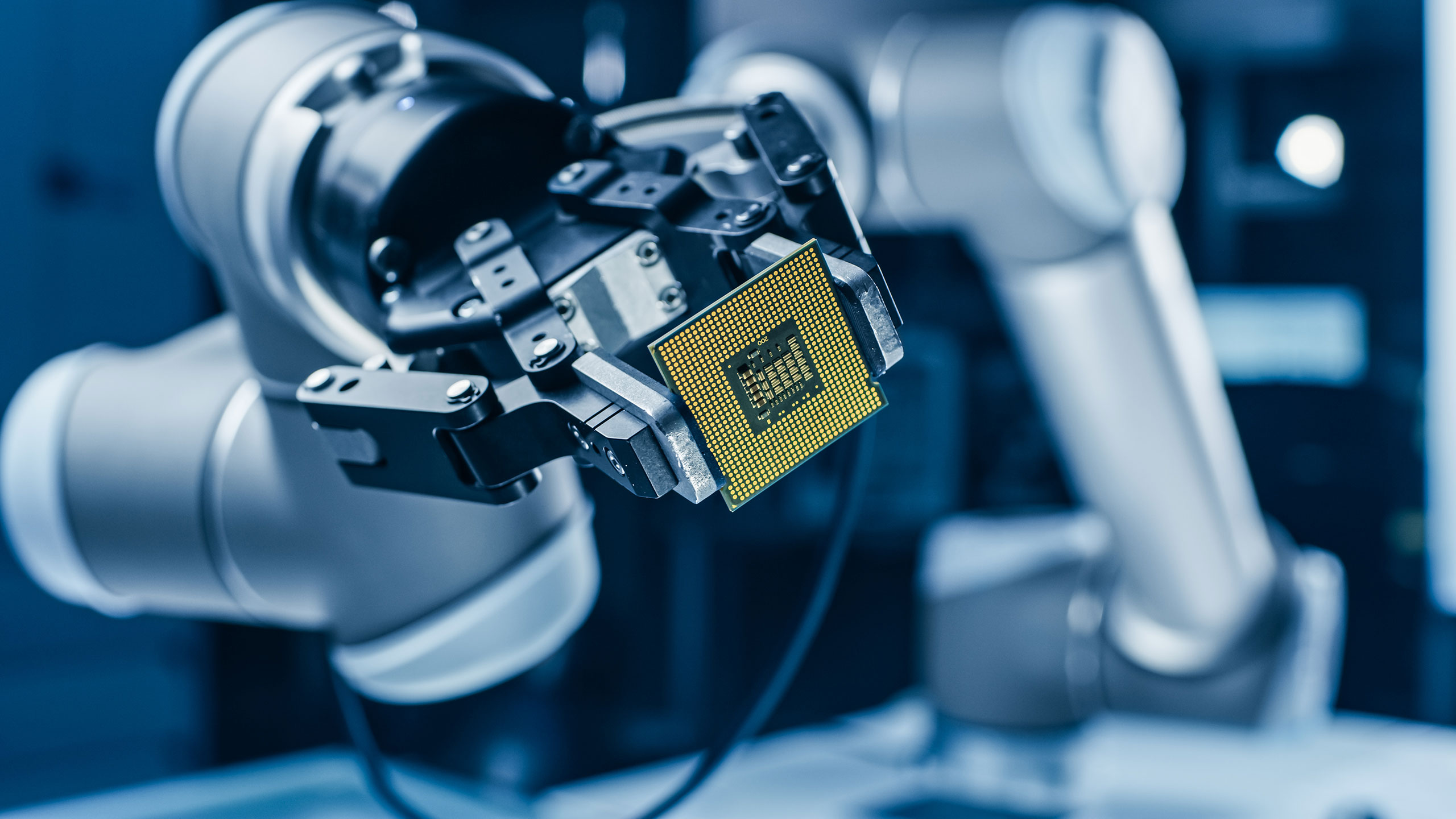 Robotic_Arm_Holding_Computer_Chip Robotic_Arm_Holding_Computer_Chip