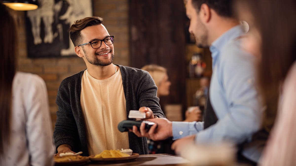 Man Paying Bill In Cafe Man Paying Bill In Cafe