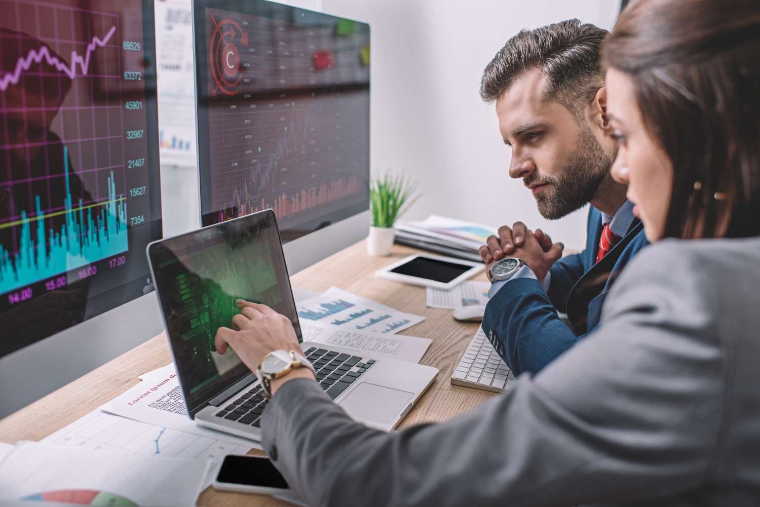 Side view of computer systems analysts using chart
