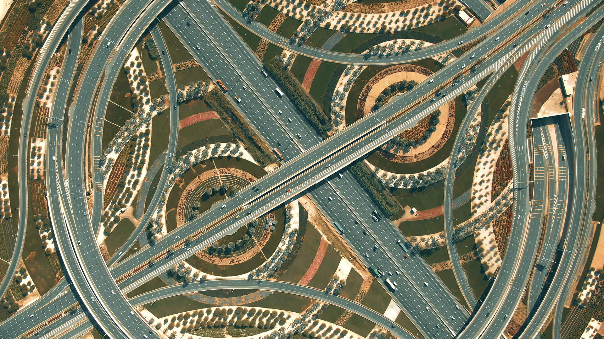 Aerial photo of a circular highway hero Big highway interchange traffic in Dubai