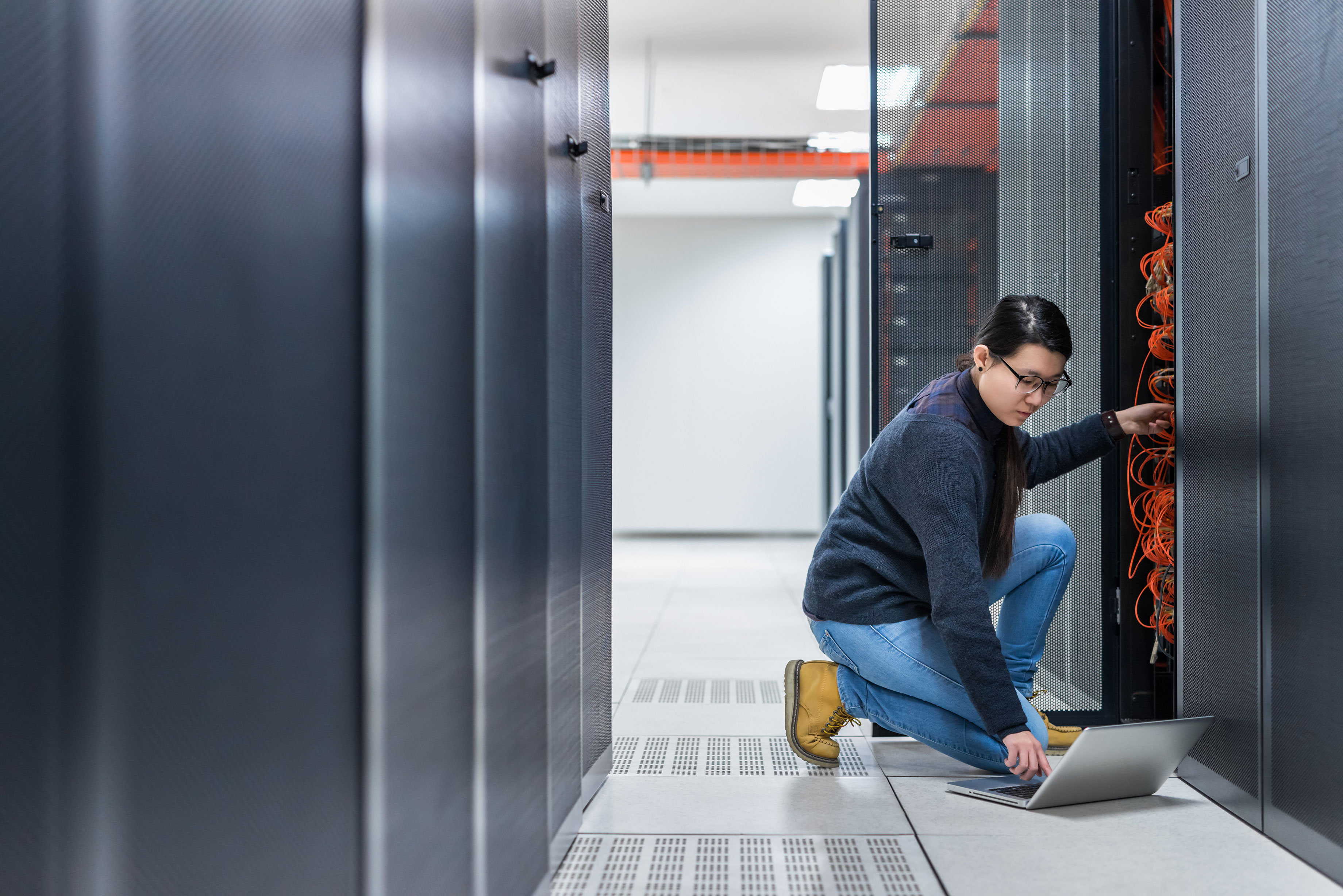 Asian_Female_Technician_Working_on_Server Asian_Female_Technician_Working_on_Server