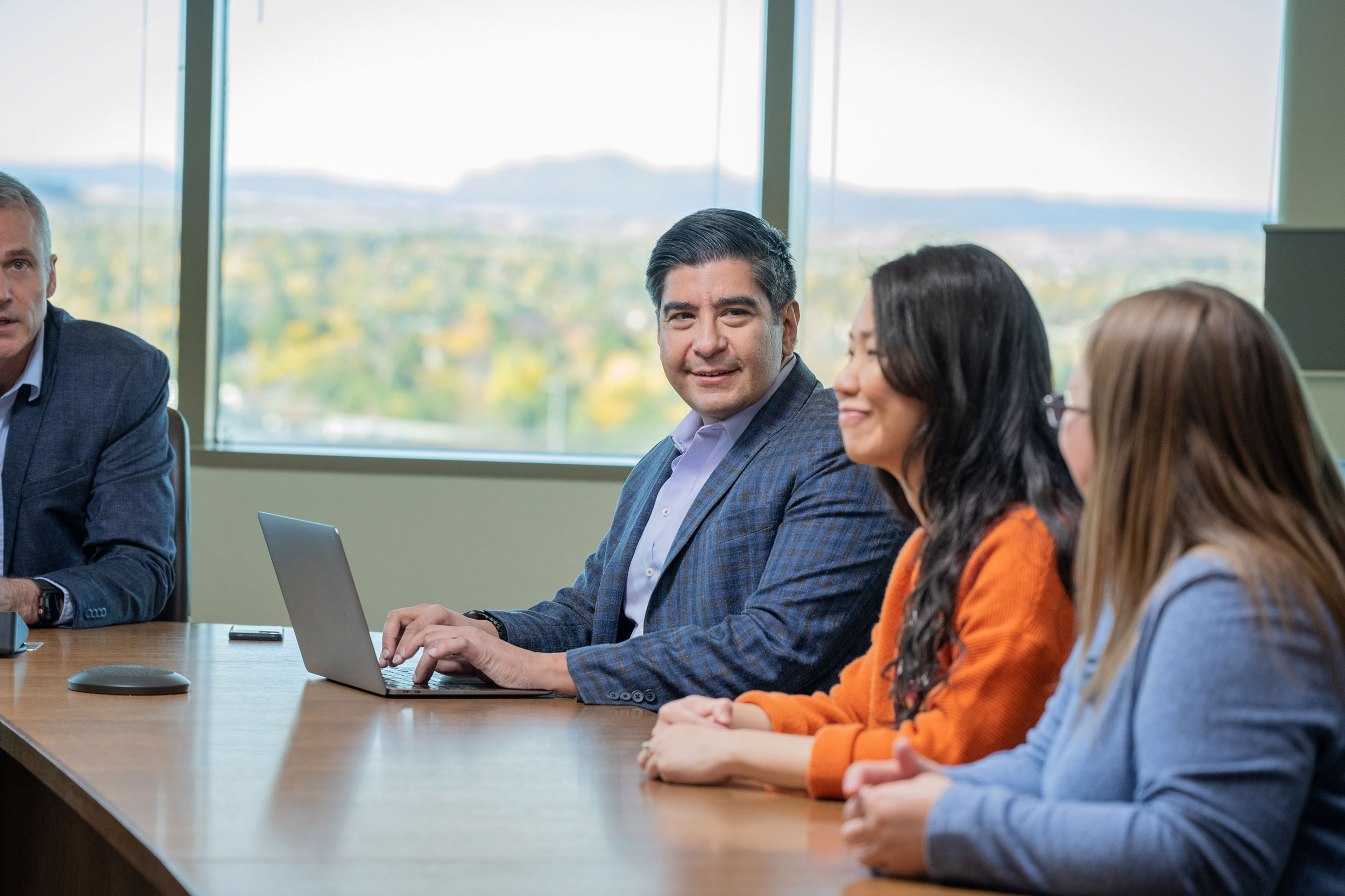 Four_People_In_Meeting_Room