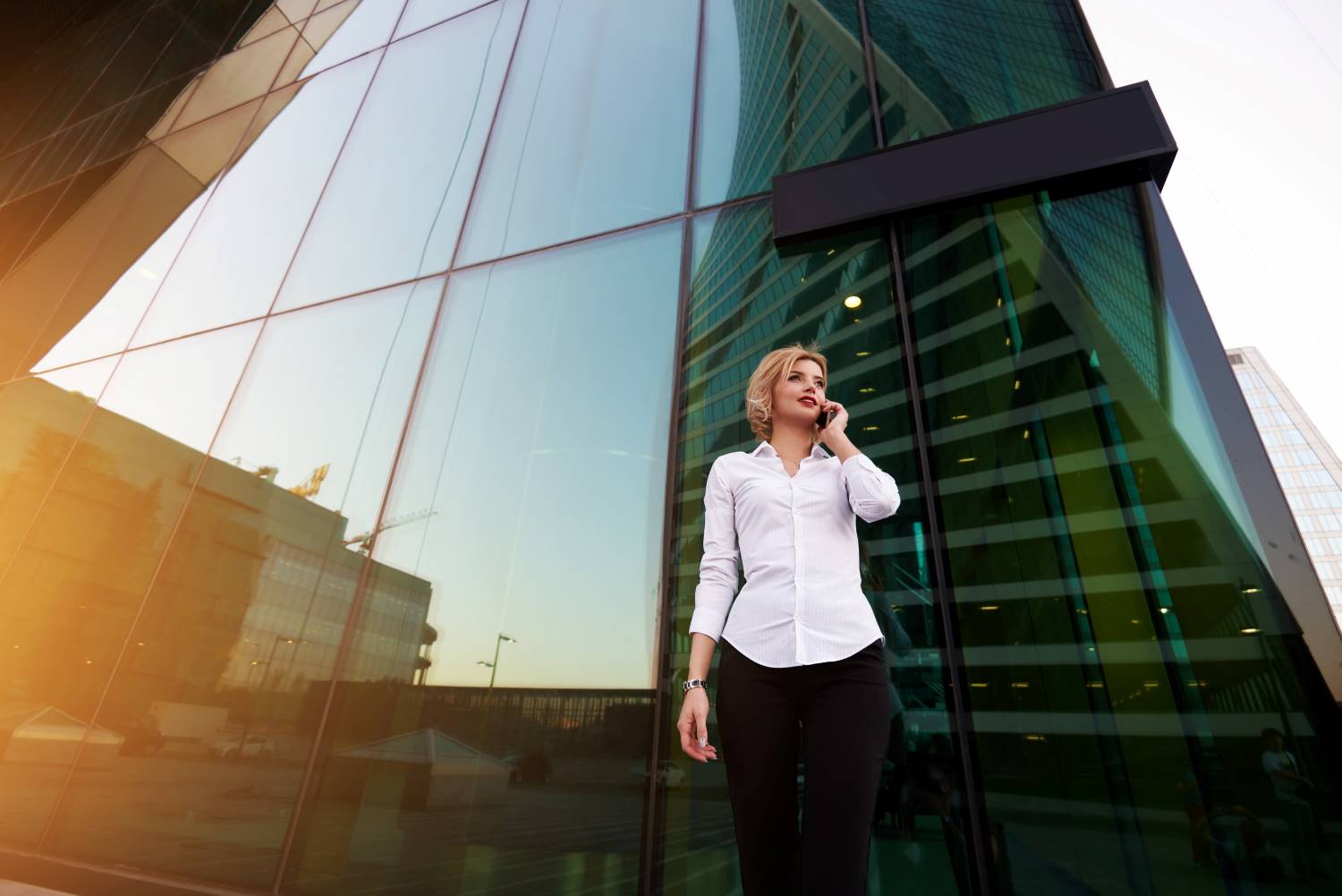 Businesswoman_on_Phone_Building_Entryway