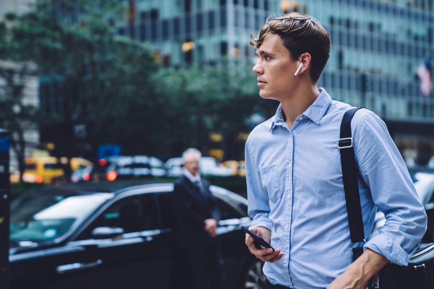Man Walking In City With Wireless Headphones