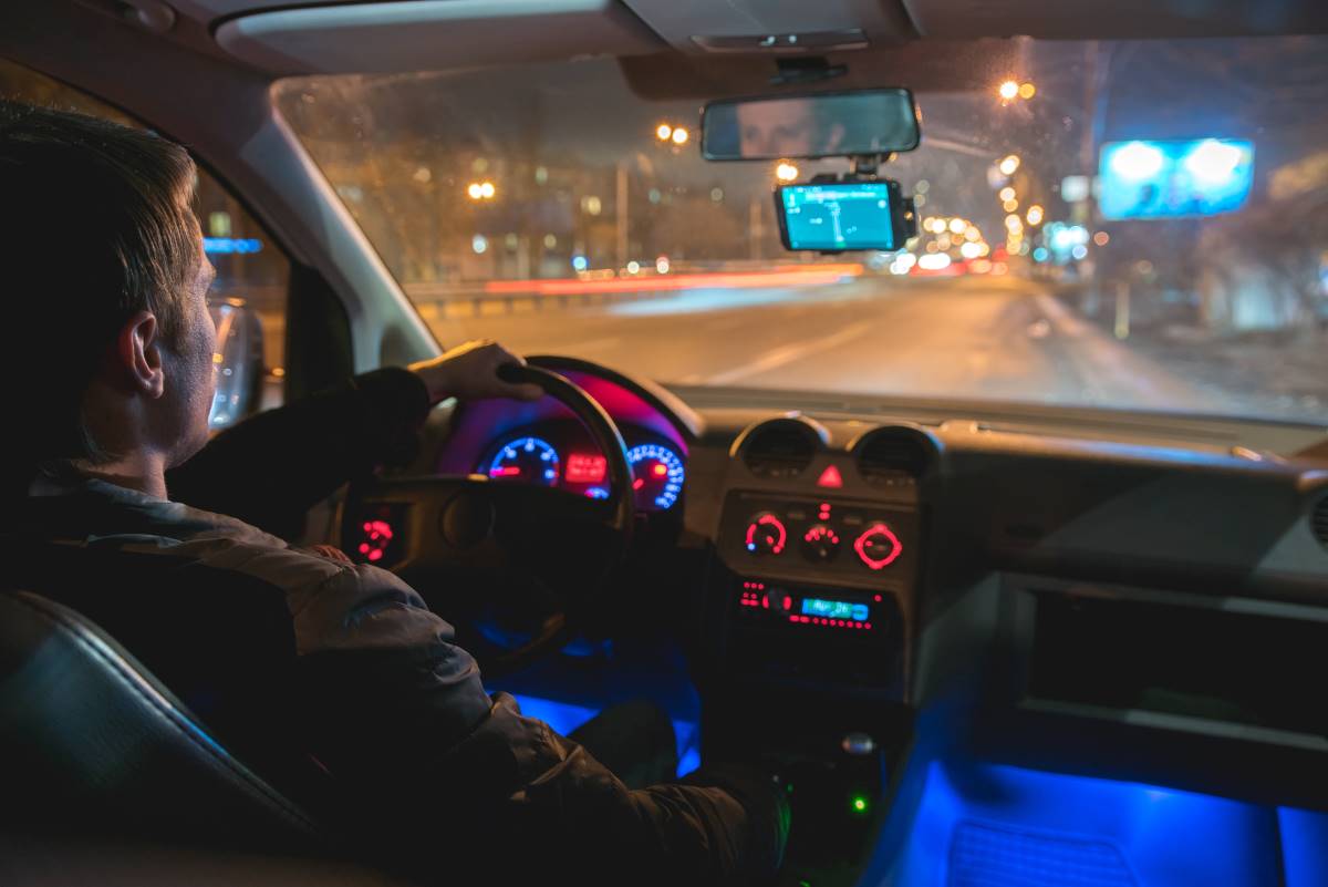 A man driving a car in the night city