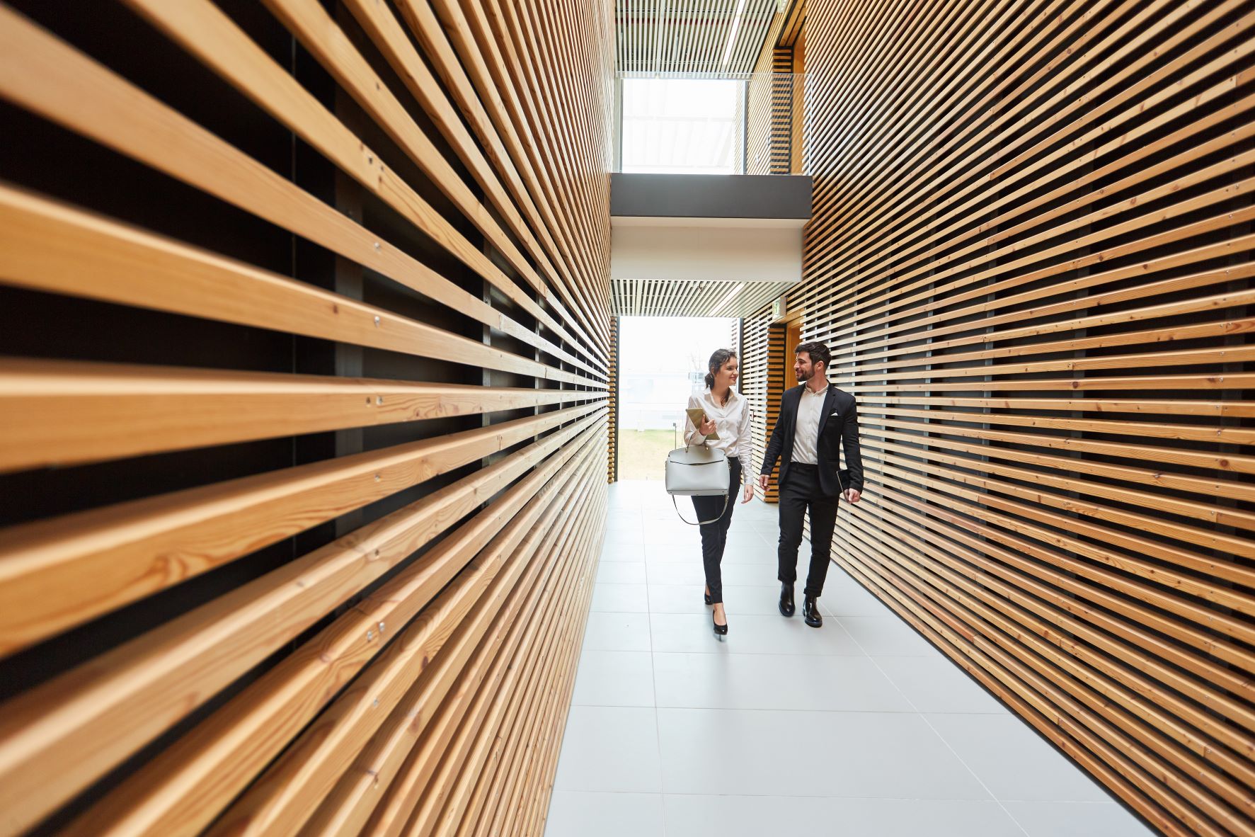 2 Business People Modern Building 2 people in a modern hallway